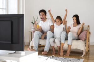 Family watching IPTV together on a Smart TV in the UK living room