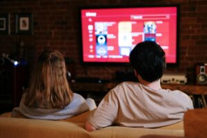 Family enjoying IPTV streaming on a large screen at home in the UK, 2025